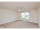 Bright bedroom featuring a ceiling fan, plush carpet, and a large window at 5891 Mimosa Dr, Indianapolis, IN 46234