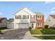 Charming two-story home with a two-car garage and well-maintained front lawn at 5891 Mimosa Dr, Indianapolis, IN 46234