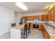 Bright kitchen with stainless steel appliances, oak cabinets, and center island with seating at 5891 Mimosa Dr, Indianapolis, IN 46234