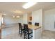 Open kitchen with island seating flows into the living room; great for entertaining at 5891 Mimosa Dr, Indianapolis, IN 46234