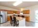 Eat-in kitchen with stainless steel appliances, central island, and light wood cabinetry at 5891 Mimosa Dr, Indianapolis, IN 46234