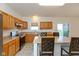 Eat-in kitchen featuring oak cabinets, stainless appliances, and a window over the sink at 5891 Mimosa Dr, Indianapolis, IN 46234