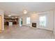 Open-concept living room with fireplace flowing into the kitchen and dining area at 5891 Mimosa Dr, Indianapolis, IN 46234