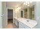 Bright main bathroom features a double vanity, large mirror, and walk-in closet access at 5891 Mimosa Dr, Indianapolis, IN 46234