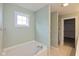 Main bathroom features a soaking tub, large window, and access to the walk-in closet at 5891 Mimosa Dr, Indianapolis, IN 46234