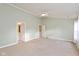 Spacious main bedroom features a ceiling fan, neutral carpet, and ensuite bath access at 5891 Mimosa Dr, Indianapolis, IN 46234