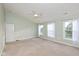 Main bedroom with neutral carpet features a ceiling fan and three bright windows at 5891 Mimosa Dr, Indianapolis, IN 46234