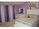 Bright bedroom with white furniture and a floral bedspread at 6056 Blackley Ct, Indianapolis, IN 46254