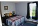 Cozy bedroom featuring a comfortable bed, soft pillows, a window, and neutral-toned walls at 6056 Blackley Ct, Indianapolis, IN 46254