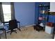 Bedroom with a large window, desk, black chair, and storage at 6056 Blackley Ct, Indianapolis, IN 46254