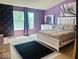 Bright bedroom with natural light, and purple walls at 6056 Blackley Ct, Indianapolis, IN 46254