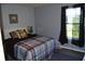 Bedroom features a cozy bed with plaid comforter and pillows at 6056 Blackley Ct, Indianapolis, IN 46254