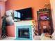 Elegant fireplace with blue tile surround, complemented by stylish decor and a mounted TV at 6056 Blackley Ct, Indianapolis, IN 46254