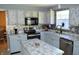 Well-appointed kitchen with gray cabinets, updated appliances, and a functional island for meal prep at 6056 Blackley Ct, Indianapolis, IN 46254