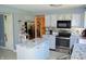 Well-appointed kitchen featuring gray cabinets, updated appliances, and a view to the breakfast nook at 6056 Blackley Ct, Indianapolis, IN 46254