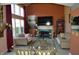 Inviting living room with a cozy fireplace, large windows, and comfortable seating at 6056 Blackley Ct, Indianapolis, IN 46254
