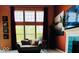 Cozy living room featuring large windows, comfortable seating, and a decorative fireplace with tile surround at 6056 Blackley Ct, Indianapolis, IN 46254