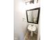 Stylish half-bathroom featuring a pedestal sink, modern fixtures, and a decorative mirror at 6213 Selago Dr, Indianapolis, IN 46203