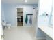 Light blue bathroom with a bathtub, a toilet, and sink vanity, offering practical features at 6213 Selago Dr, Indianapolis, IN 46203