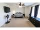 Neutral bedroom featuring a ceiling fan, windows, and carpet, providing a comfortable and spacious environment at 6213 Selago Dr, Indianapolis, IN 46203