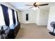 Spacious room featuring a ceiling fan, windows, and carpet, creating an open and adaptable living space at 6213 Selago Dr, Indianapolis, IN 46203