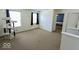Carpeted bedroom with two windows, a cat tree and a view into another bedroom at 6213 Selago Dr, Indianapolis, IN 46203