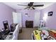 Light purple bedroom featuring a ceiling fan, windows, and neutral carpet, creating a comfortable and versatile area at 6213 Selago Dr, Indianapolis, IN 46203