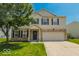 Charming two-story home with a well-maintained lawn and a two-car garage at 6213 Selago Dr, Indianapolis, IN 46203
