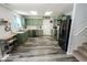 Updated kitchen with stainless steel appliances, plenty of counter space, and stylish light fixtures at 6213 Selago Dr, Indianapolis, IN 46203