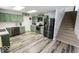 Contemporary kitchen with stainless steel appliances and convenient access to the stairs at 6213 Selago Dr, Indianapolis, IN 46203