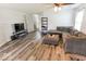 Open concept living room featuring new flooring, ample natural light, and comfortable furniture at 6213 Selago Dr, Indianapolis, IN 46203