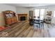 Open concept living and dining area with wood burning fireplace, new flooring, and natural light at 6213 Selago Dr, Indianapolis, IN 46203