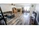 Open concept living room with wood burning fireplace, new flooring, and dining area at 6213 Selago Dr, Indianapolis, IN 46203