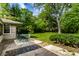 Well-maintained backyard with a patio, lush greenery, and mature trees, ideal for outdoor enjoyment at 6220 Spring Mill Rd, Indianapolis, IN 46260