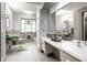 Vintage-inspired bathroom features stylish grey and white tiling, and unique green fixtures at 6220 Spring Mill Rd, Indianapolis, IN 46260