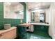 Retro bathroom featuring green tile and pink fixtures at 6220 Spring Mill Rd, Indianapolis, IN 46260