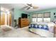 Light and airy bedroom featuring carpeted floors, natural light, and a ceiling fan at 6220 Spring Mill Rd, Indianapolis, IN 46260
