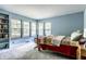 Bright bedroom features large windows, blue walls, and comfortable carpeted floors at 6220 Spring Mill Rd, Indianapolis, IN 46260