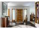 Inviting foyer with slate floors, wood door, and decorative accents at 6220 Spring Mill Rd, Indianapolis, IN 46260