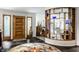 Open foyer with slate flooring, decorative shelves, and living room access at 6220 Spring Mill Rd, Indianapolis, IN 46260
