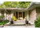 Front porch featuring a yellow chair, potted plants, and a stone facade at 6220 Spring Mill Rd, Indianapolis, IN 46260