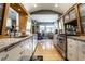 Modern kitchen with stainless steel appliances, wood and white cabinetry, and an open layout into the breakfast nook at 6220 Spring Mill Rd, Indianapolis, IN 46260