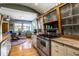 Contemporary kitchen with stainless steel appliances, wood and white cabinetry, and an open layout into the dining area at 6220 Spring Mill Rd, Indianapolis, IN 46260
