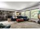 Spacious living room with stone fireplace and a large blue couch at 6220 Spring Mill Rd, Indianapolis, IN 46260