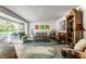 Spacious living room with large windows, hardwood floors, and stylish furniture at 6220 Spring Mill Rd, Indianapolis, IN 46260