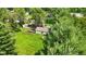 View of the home, with a garden area and fire pit, surrounded by lush greenery and well-maintained lawn at 71 W County Road 500 S, Clayton, IN 46118