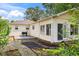 Rear exterior of home with deck, brick patio, and well-maintained landscaping at 71 W County Road 500 S, Clayton, IN 46118
