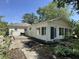 Charming single-story home featuring an open patio and a sunroom lined with windows at 71 W County Road 500 S, Clayton, IN 46118