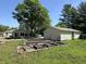 Property featuring a single-story house and a fenced garden with a three-car garage at 71 W County Road 500 S, Clayton, IN 46118
