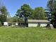 Exterior view of a home with a fenced garden area at 71 W County Road 500 S, Clayton, IN 46118